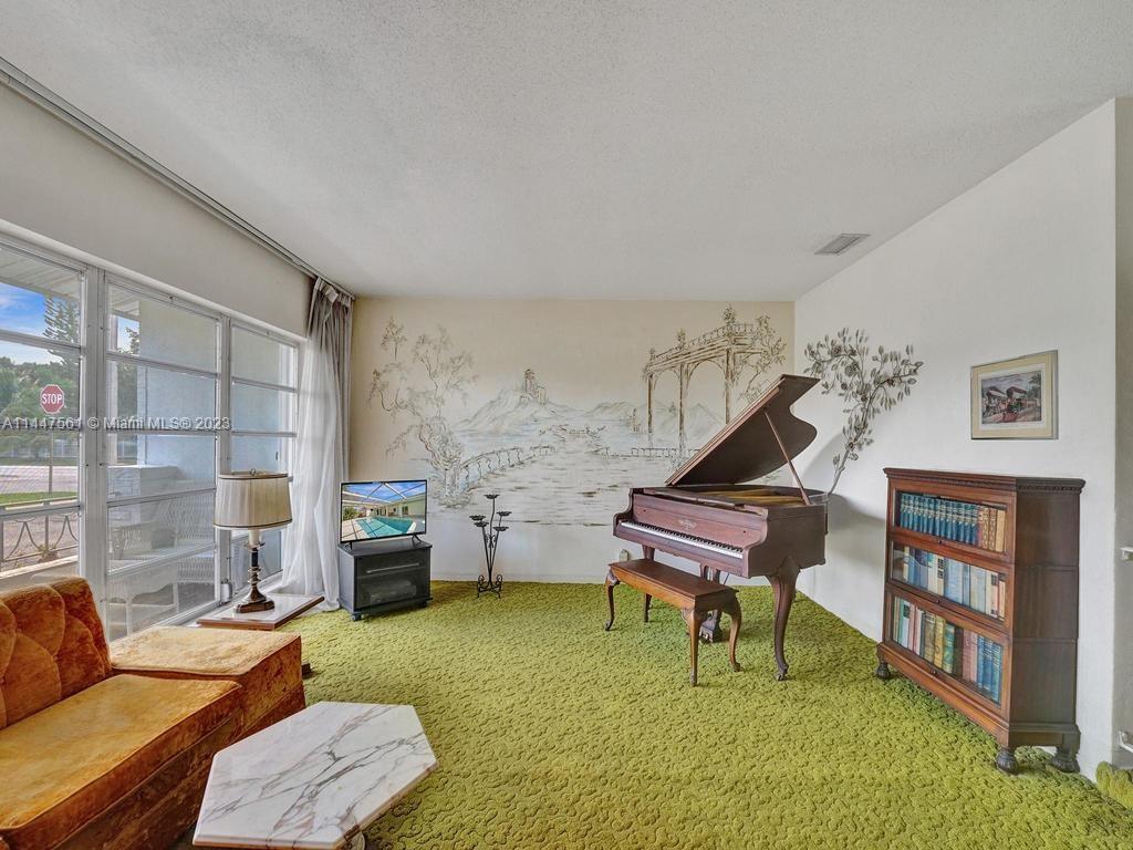5525 Jackson Street Hollywood, FL 33021 - Photo 42 of 91 a living room with furniture and a piano