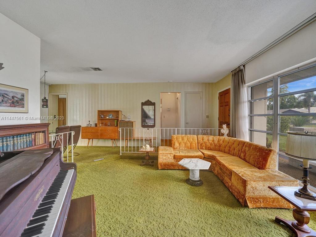 5525 Jackson Street Hollywood, FL 33021 - Photo 45 of 91 a living room with furniture and a table