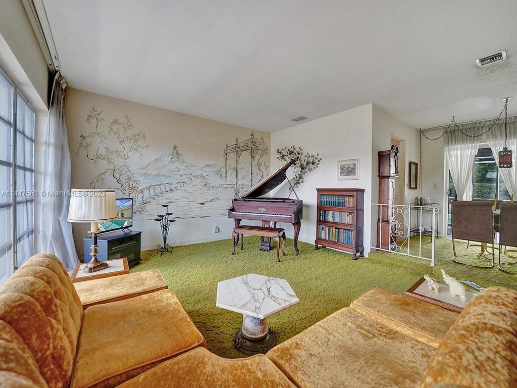 5525 Jackson Street Hollywood, FL 33021 - Photo 5 of 91 a living room with furniture and a fireplace