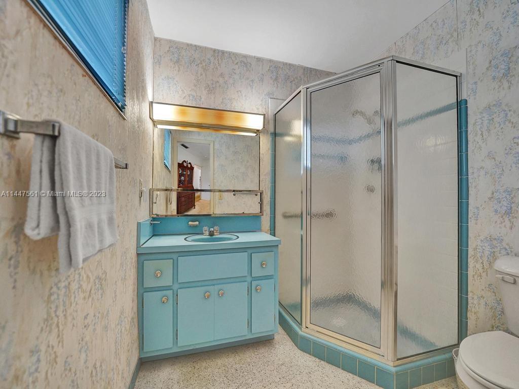 5525 Jackson Street Hollywood, FL 33021 - Photo 51 of 91 a bathroom with a shower sink and mirror