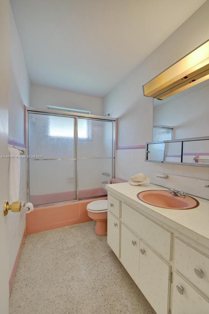 5525 Jackson Street Hollywood, FL 33021 - Photo 56 of 91 a bathroom with a granite countertop sink mirror vanity and toilet