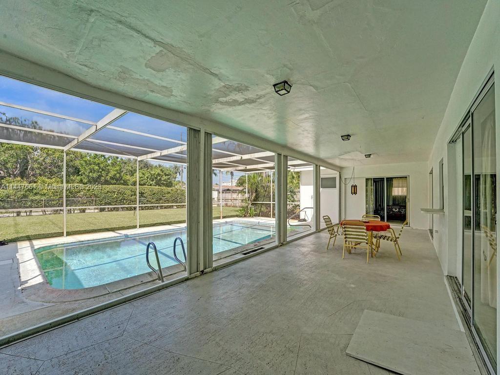 5525 Jackson Street Hollywood, FL 33021 - Photo 59 of 91 a living room with furniture and floor to ceiling windows