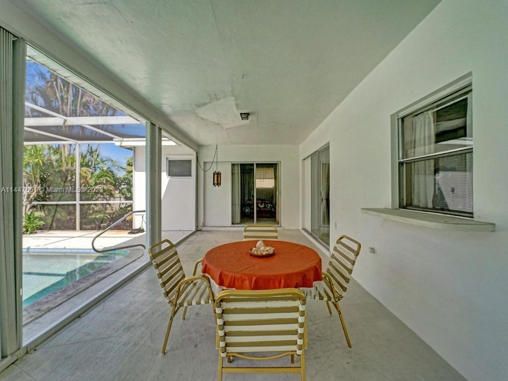 5525 Jackson Street Hollywood, FL 33021 - Photo 60 of 91 a view of a dining room with furniture wooden floor and windows