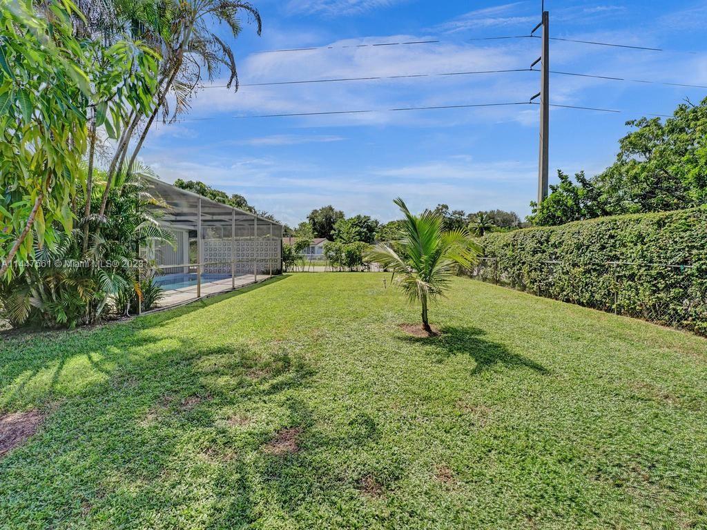 5525 Jackson Street Hollywood, FL 33021 - Photo 73 of 91 a garden with trees in front of it