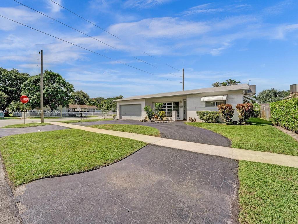5525 Jackson Street Hollywood, FL 33021 - Photo 80 of 91 a view of a big house with a big yard and palm trees