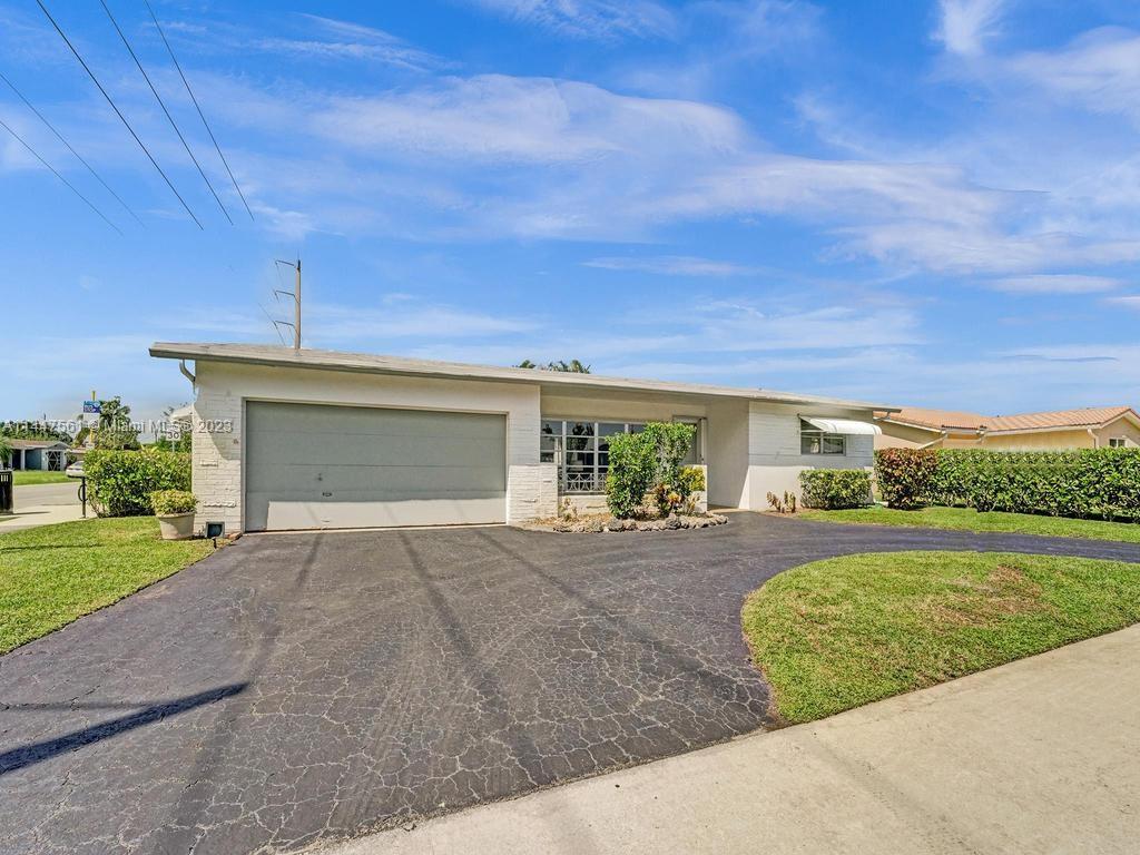 5525 Jackson Street Hollywood, FL 33021 - Photo 83 of 91 a front view of a house with a yard and garage
