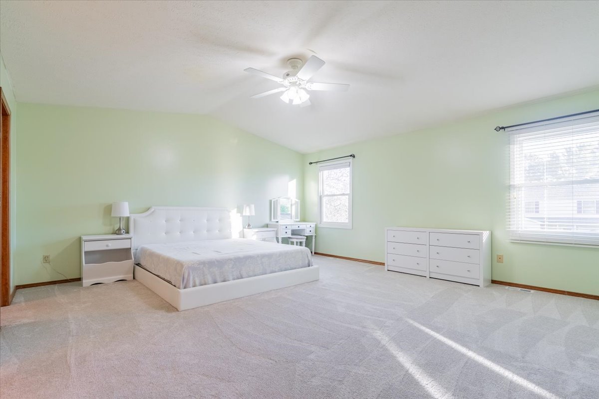 1314 Lismore Lane Normal, IL 61761 - Photo 14 of 26 a spacious bedroom with a bed and a chandelier