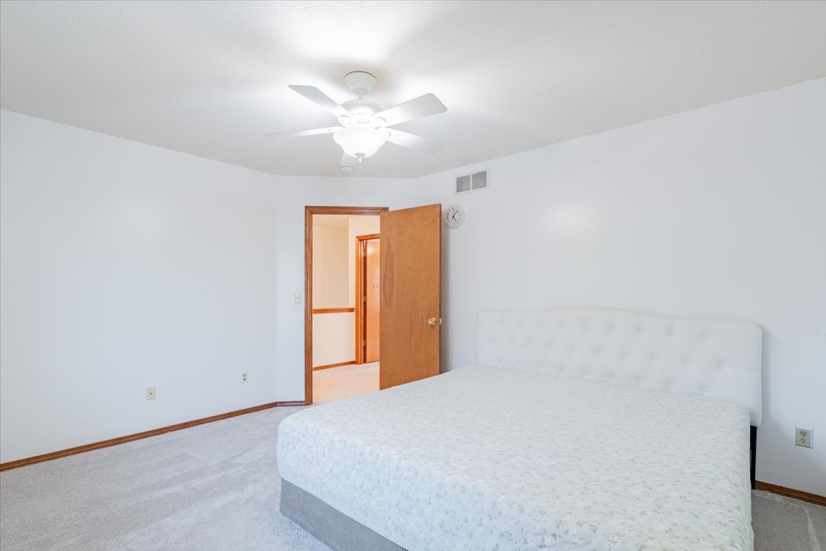1314 Lismore Lane Normal, IL 61761 - Photo 19 of 26 a bedroom with a bed and a chandelier