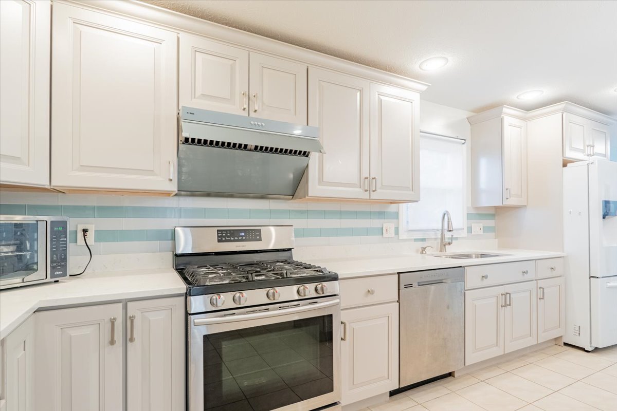 1314 Lismore Lane Normal, IL 61761 - Photo 6 of 26 a kitchen with white cabinets and white appliances