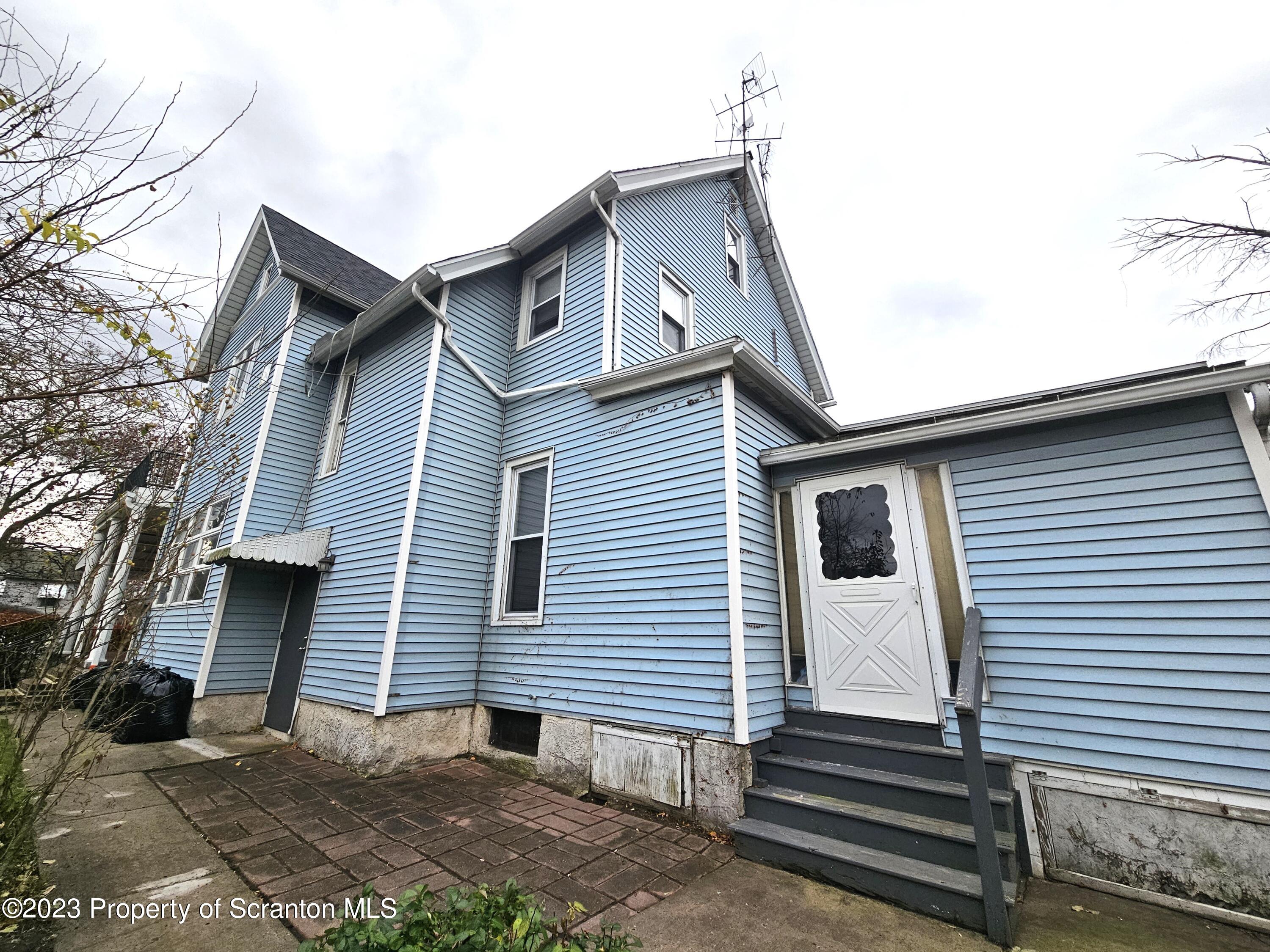 828 Cedar Avenue Scranton, PA 18505 - Photo 12 of 13 a front view of a house with a yard