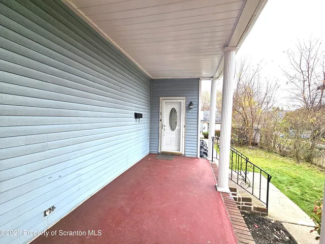 a view of a porch with wooden floor and fence