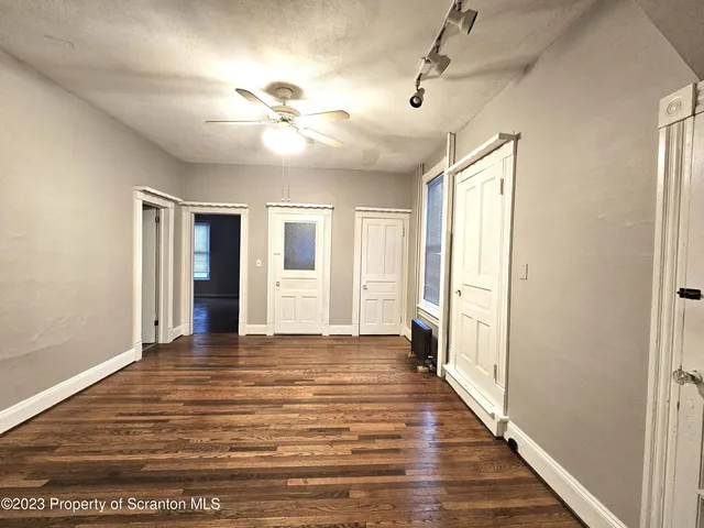 a view of a livingroom with a ceiling fan and window