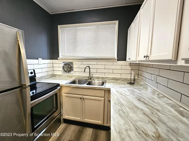 a kitchen with a sink stove and refrigerator