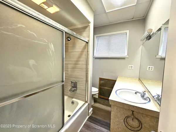a bathroom with a sink a mirror and a shower