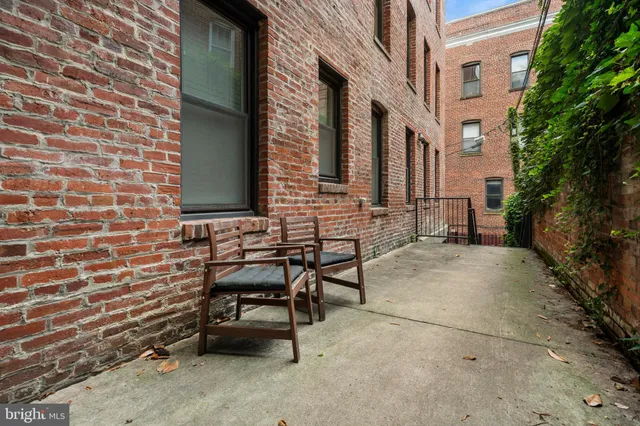 a view of a brick building with many windows