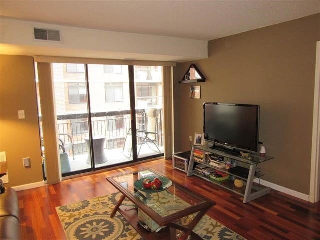 700 1st Street, Unit 12B Hoboken, NJ 07030 - Photo 2 of 10 a living room with furniture and a flat screen tv