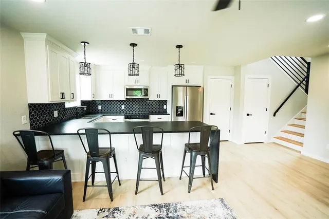 a dining room with furniture and wooden floor