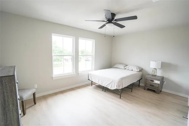 a bed sitting in a bedroom next to a window