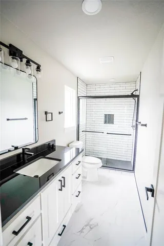 a bathroom with a sink a mirror and a shower