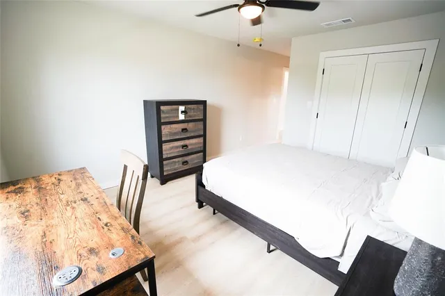 a bedroom with a bed and a dresser