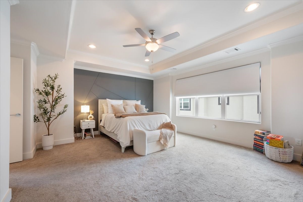 1333 West 22nd Street, Unit F Houston, TX 77008 - Photo 7 of 22 This spacious primary bedroom features a modern design with a cozy bed, neutral carpeting, and ample natural light from large windows. Just wait until you see the spa retreat en-suite bathroom!