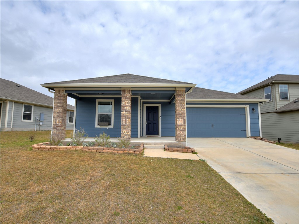 714 Liard River Road Hutto, TX 78634 - Photo 1 of 1 a front view of a house with a garden