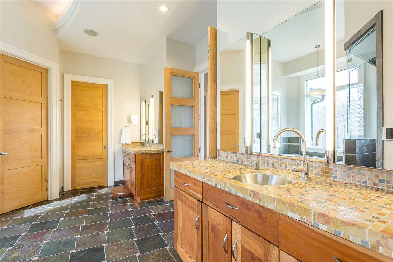 1117 Baslow Brook Court Raleigh, NC 27614 - Photo 18 of 30 Two separate custom-built cherry vanities feature custom limestone mosaic countertops,stainless-steel sinks, pull-out drawers w/Hafele hardware and under-cabinet night lights. Contemporary Robern dual mirrored & lighted medicine cabinets grace each vanity Dual Master Bath Vanities