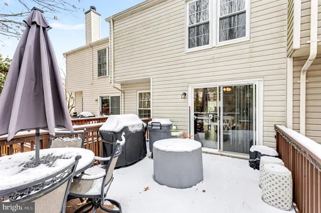 a view of a patio with a dining table and chairs