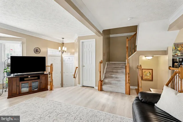 a view of a livingroom with wooden floor and furniture