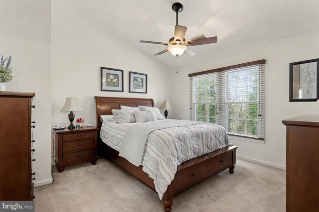 a spacious bedroom with a bed and a window