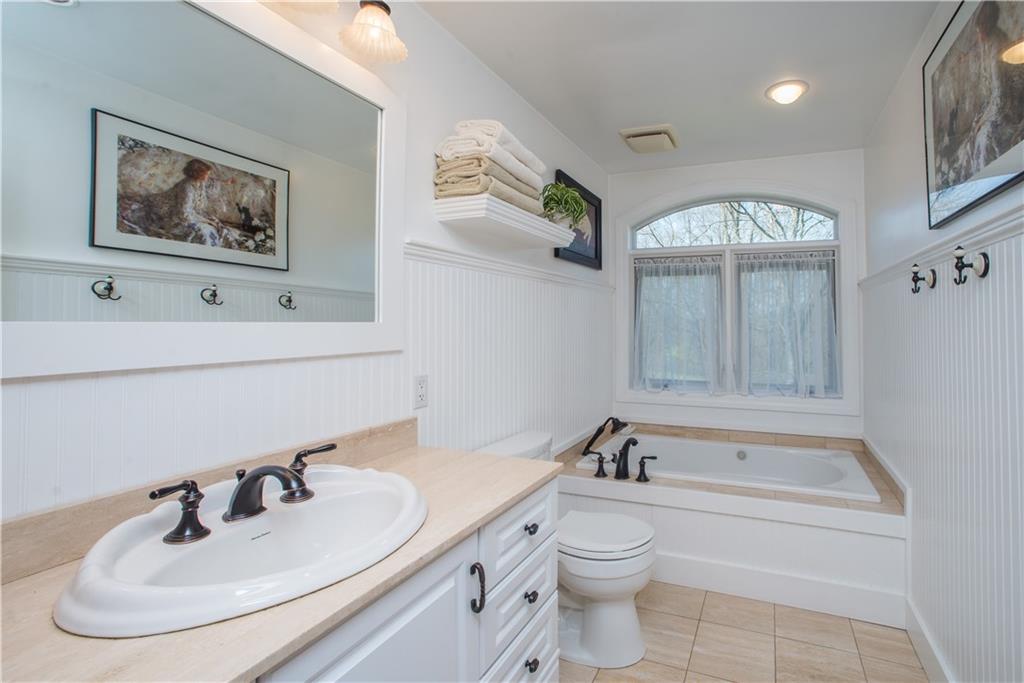 443 North Lewis Run Road West Mifflin, PA 15122 - Photo 17 of 25 The bathroom was redone with quality in mind. Enjoy Traverteen flooring and countertop as well as Azec paneling.