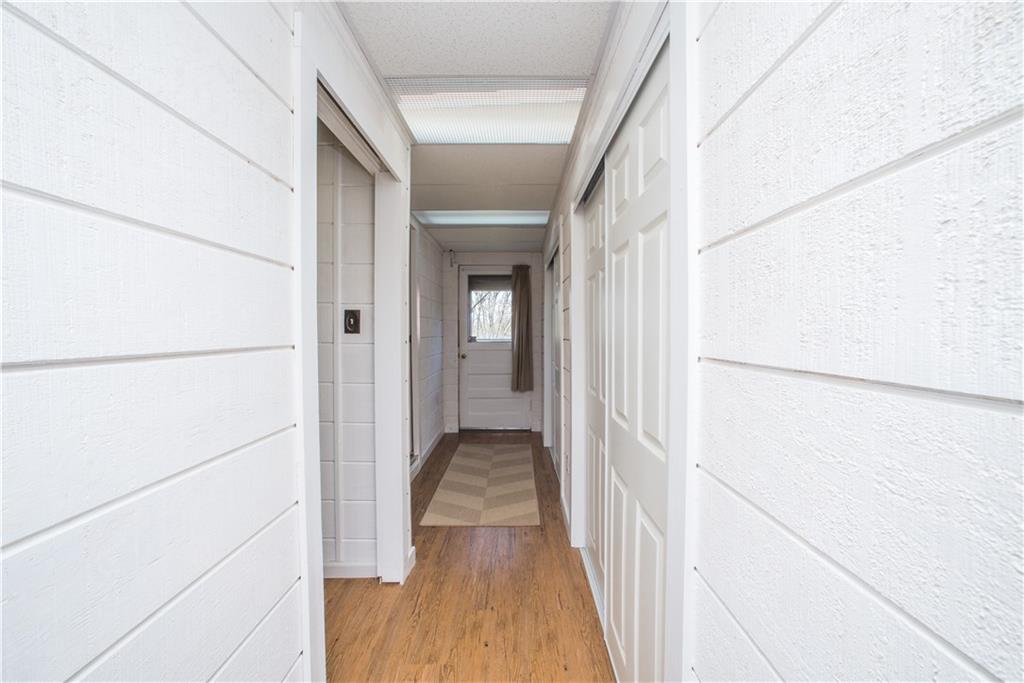 443 North Lewis Run Road West Mifflin, PA 15122 - Photo 20 of 25 The hallway from the third bedroom is lined with storage hid behind beautiful wood plank walls.