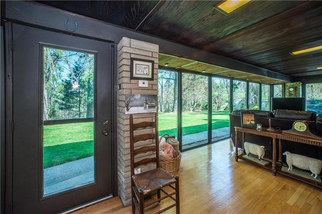 443 North Lewis Run Road West Mifflin, PA 15122 - Photo 4 of 25 The 4 season room includes a Franklin Stove and thermopane windows.
