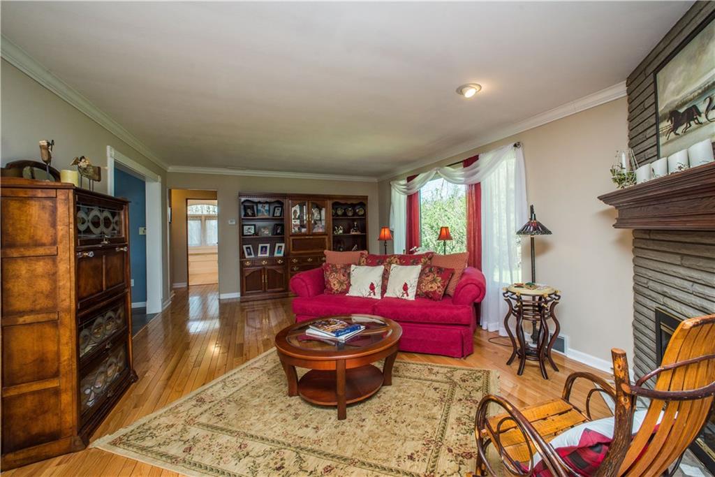 443 North Lewis Run Road West Mifflin, PA 15122 - Photo 6 of 25 Oak hardwood floors line the large living room floors as light pours in from the large window.