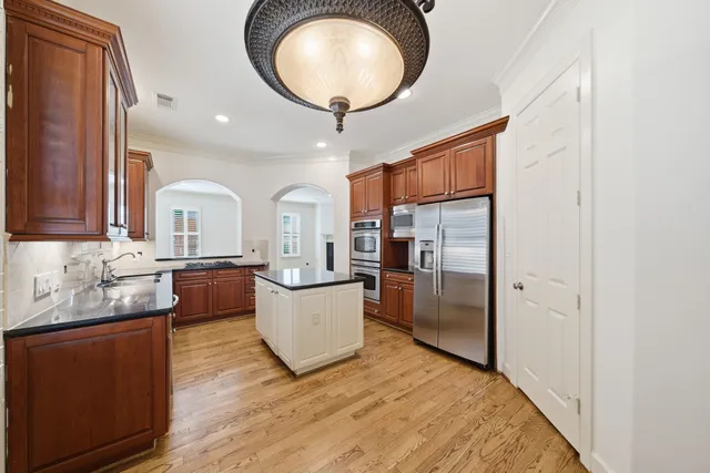 a large kitchen with stainless steel appliances and a sink