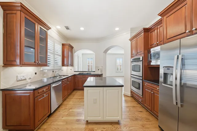 an empty room with windows and ceiling fan