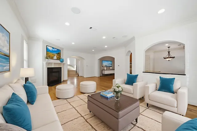 a living room with furniture a rug and a fireplace