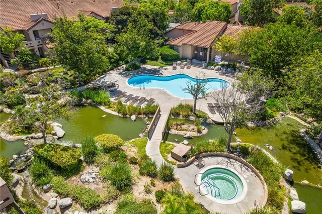an aerial view of residential house with outdoor space and swimming pool