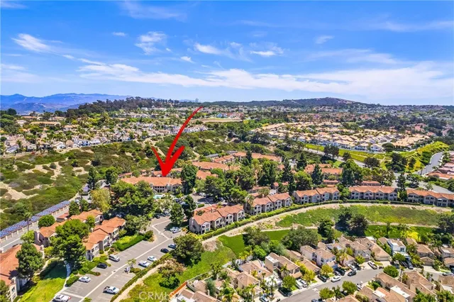 an aerial view of residential houses with outdoor space and swimming pool