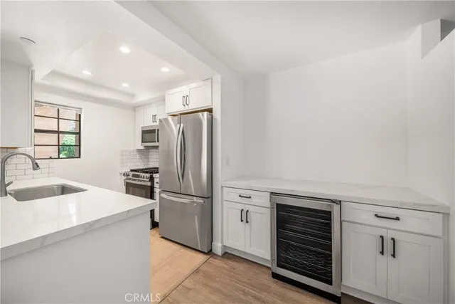 a kitchen with refrigerator cabinets and a sink