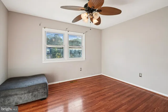 a view of room with hardwood floor and ceiling fan