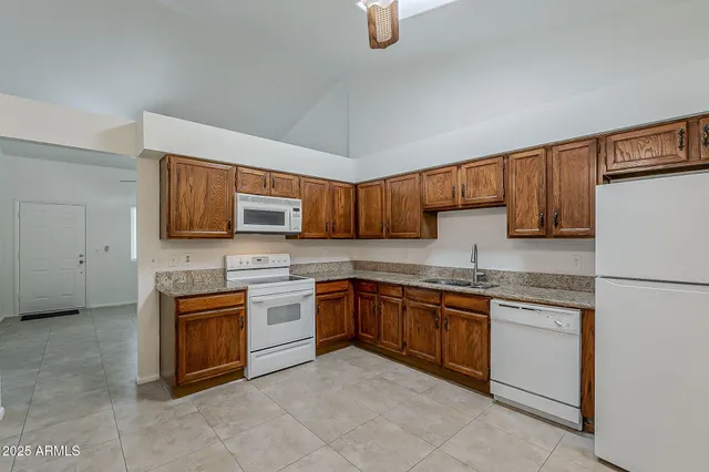 a kitchen with stainless steel appliances granite countertop a stove a sink and dishwasher