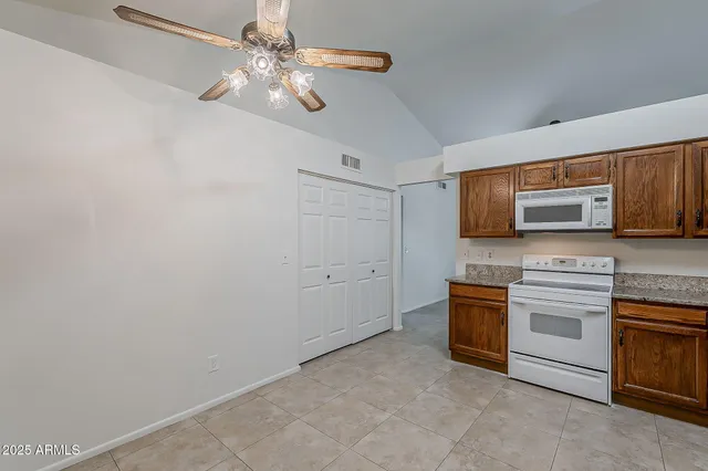 an empty room with a ceiling fan and a window