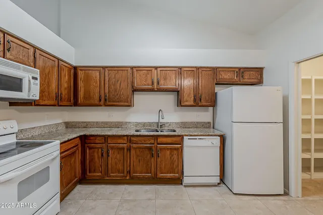 a kitchen with stainless steel appliances granite countertop a stove microwave and sink