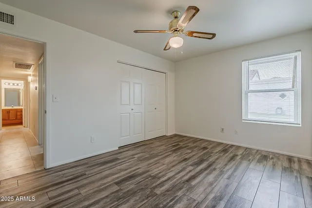 a view of empty room with wooden floor