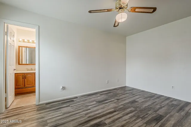 a bathroom with a granite countertop sink mirror vanity and toilet