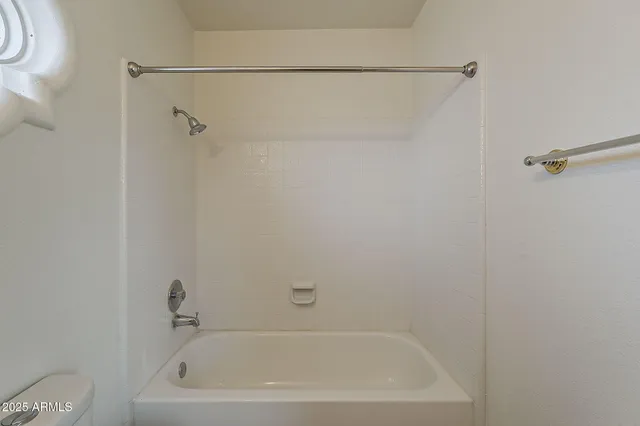 a bathroom with a sink vanity and toilet
