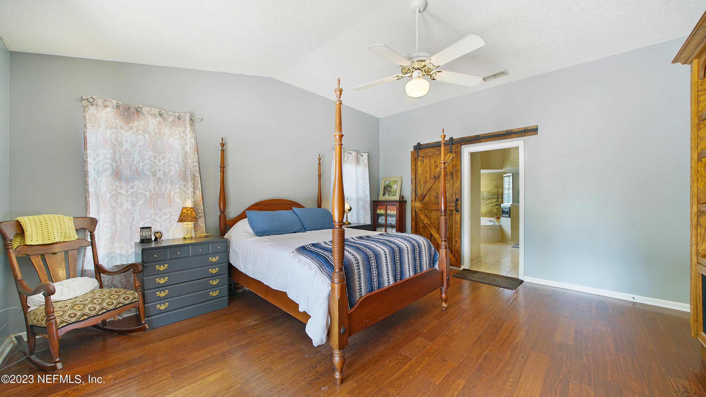 644 Hummingbird Court St. Johns, FL 32259 - Photo 21 of 36 a spacious bedroom with a bed and a chandelier