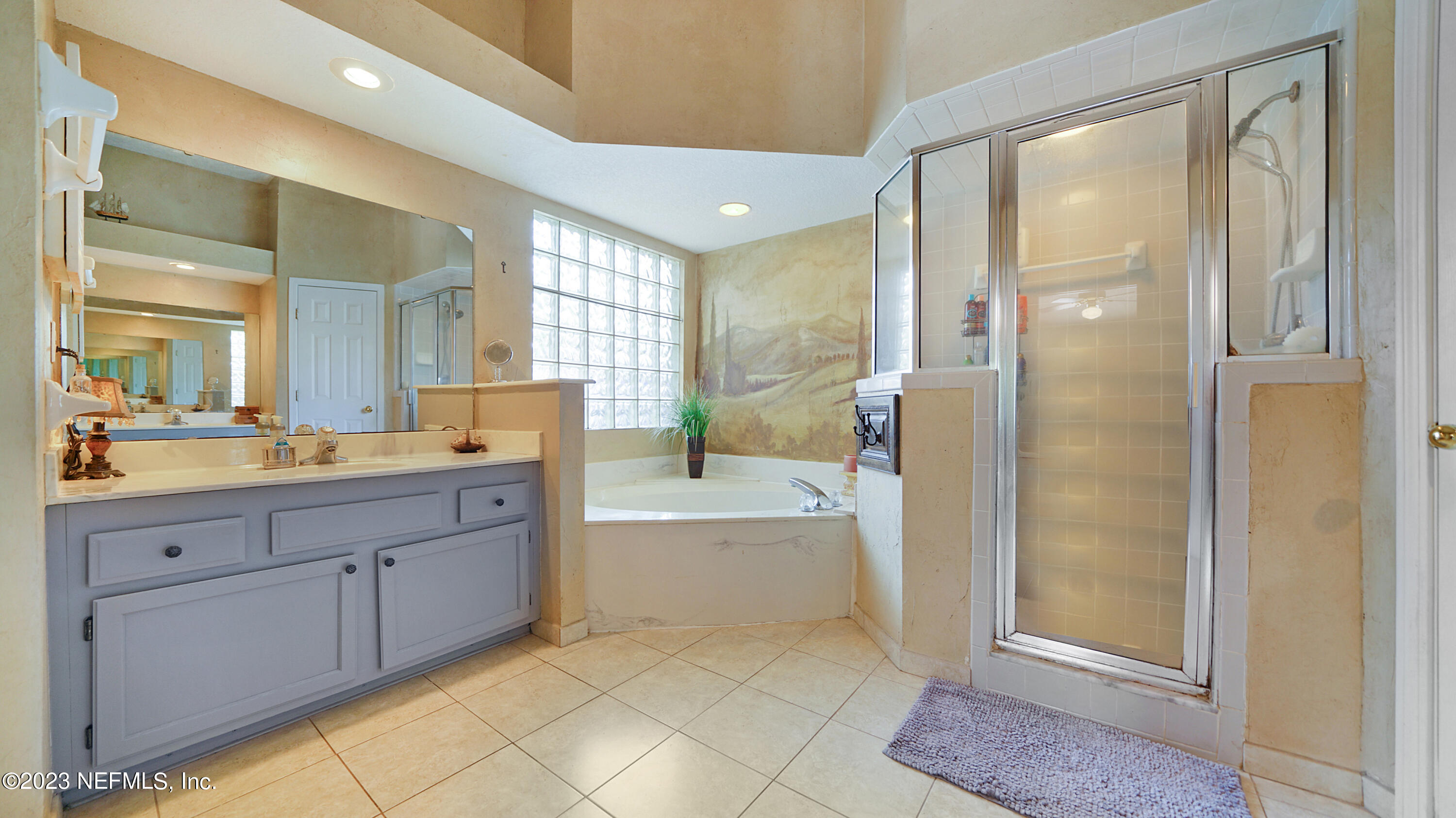 644 Hummingbird Court St. Johns, FL 32259 - Photo 22 of 36 a spacious bathroom with a mirror a sink and shower
