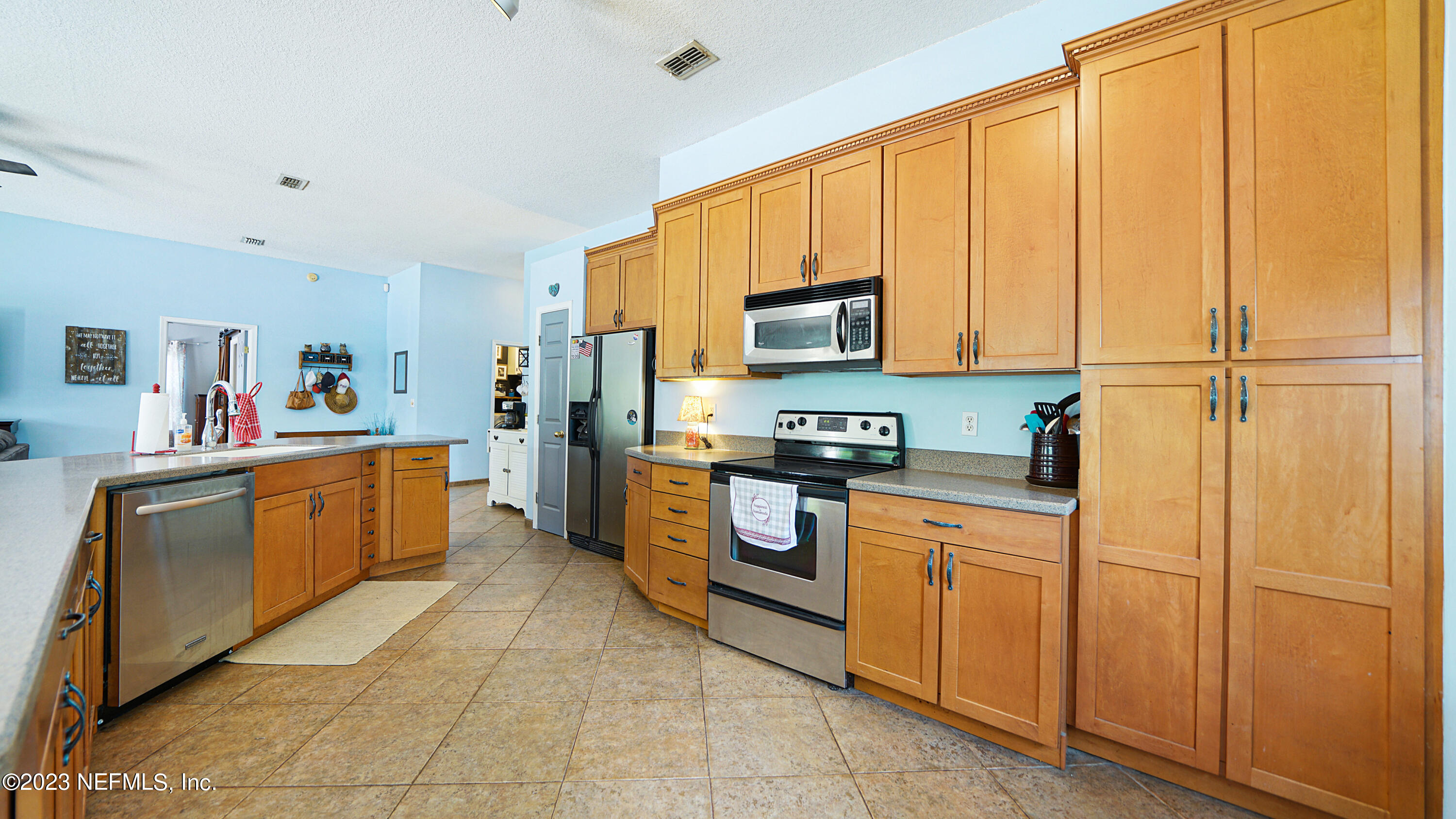 644 Hummingbird Court St. Johns, FL 32259 - Photo 6 of 36 a kitchen with stainless steel appliances a refrigerator sink and stove